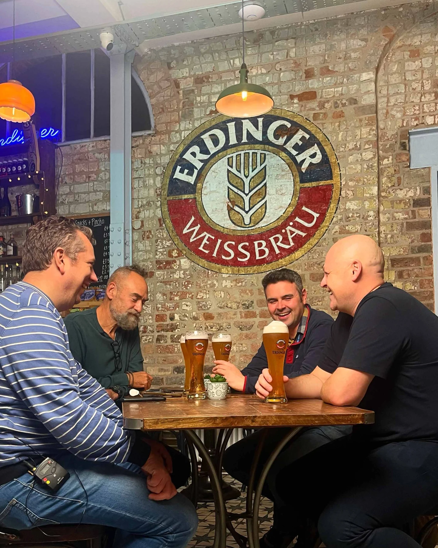 The Friday Night recorded beneath an ERDINGER sign