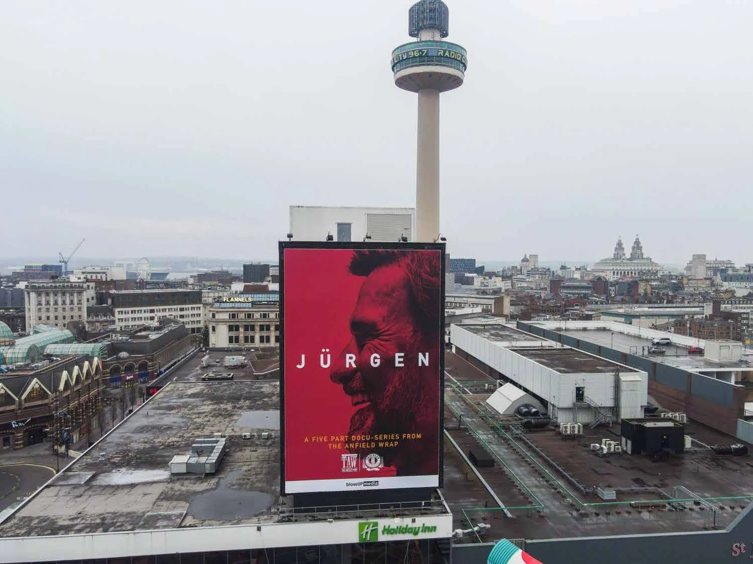 The JÜRGEN billboard overlooking Liverpool with the Radio City tower behind it