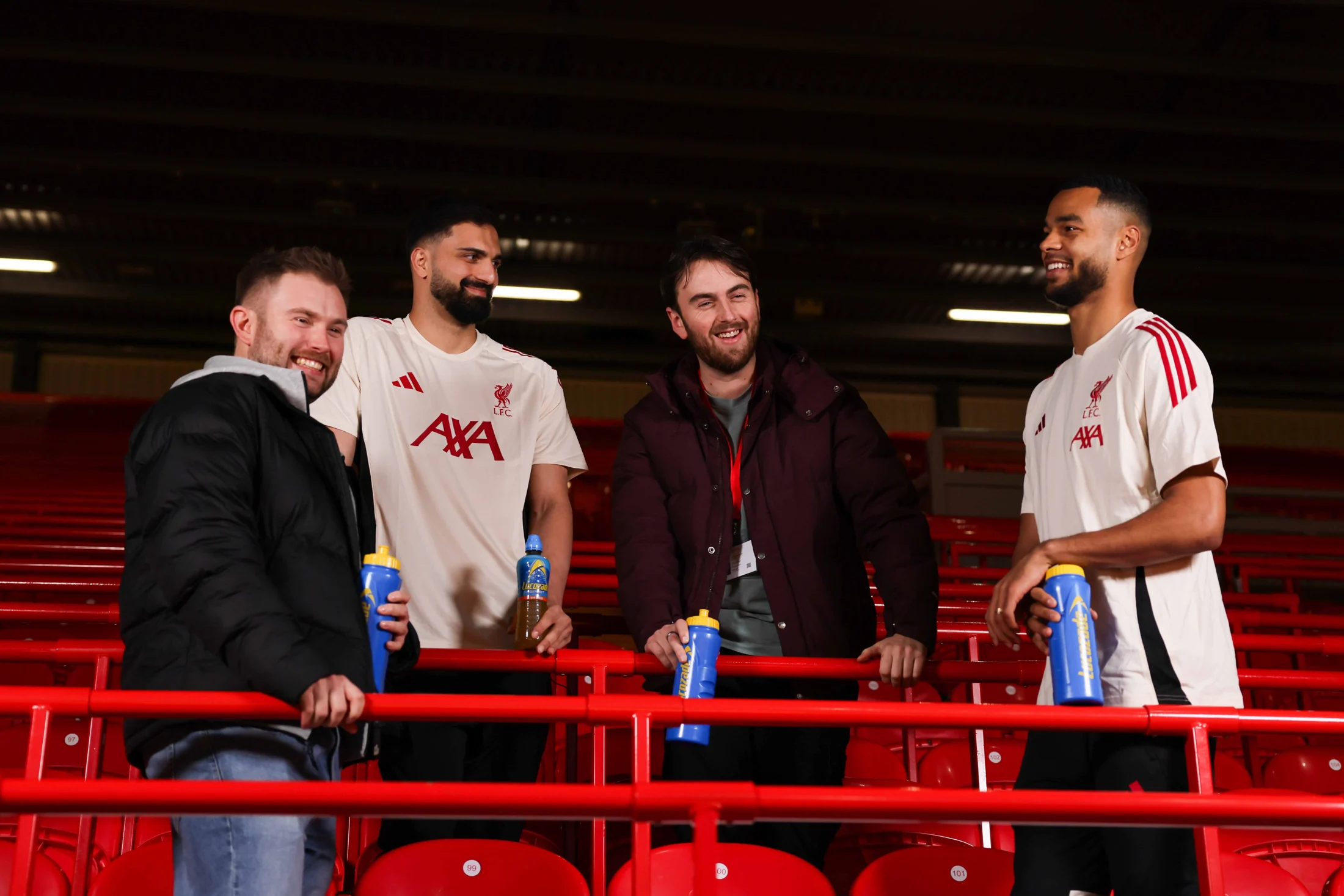 Liverpool players and supporters together on the Kop for the Lucozade campaign