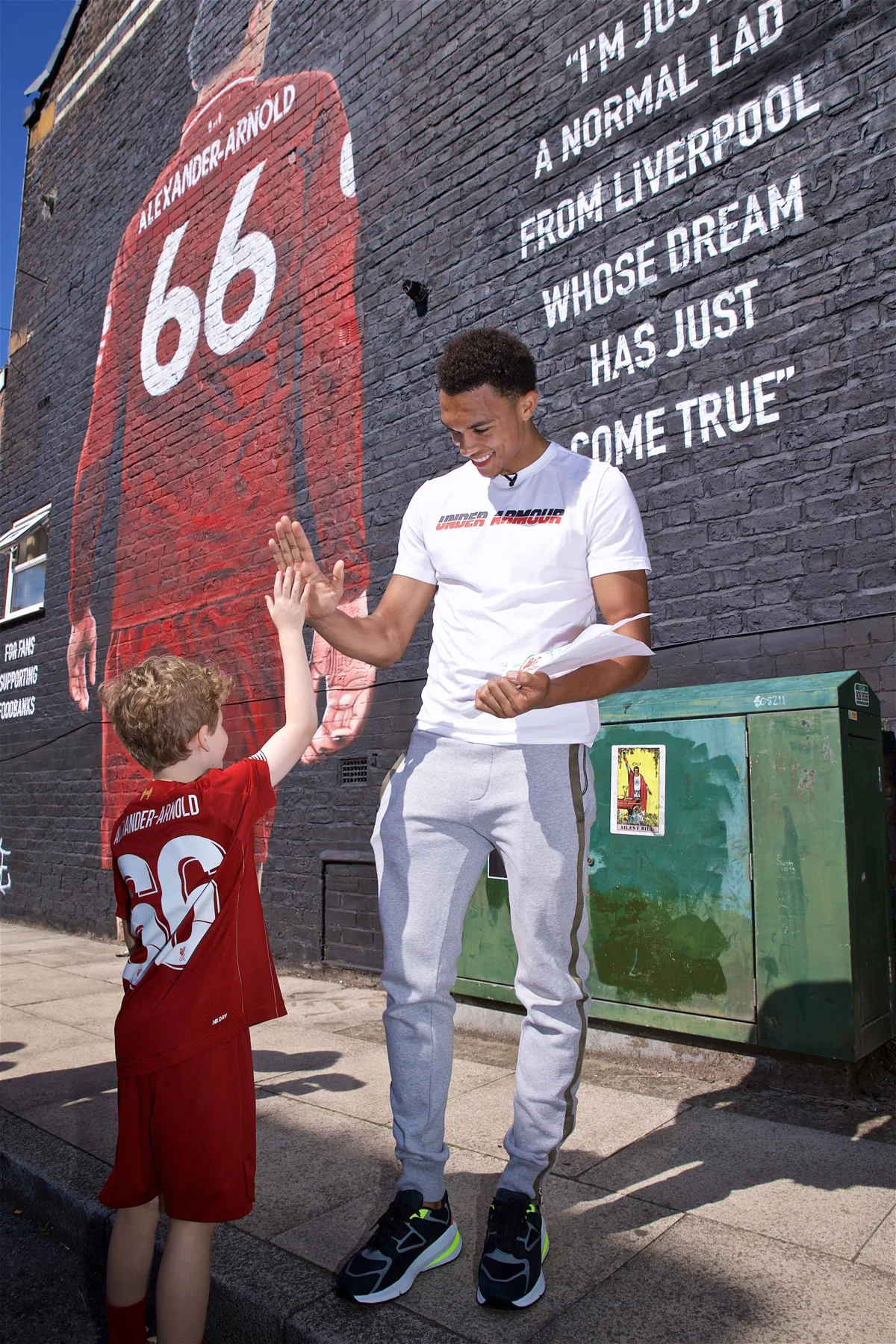Trent Alexander-Arnold meeting a young supporter beside his mural