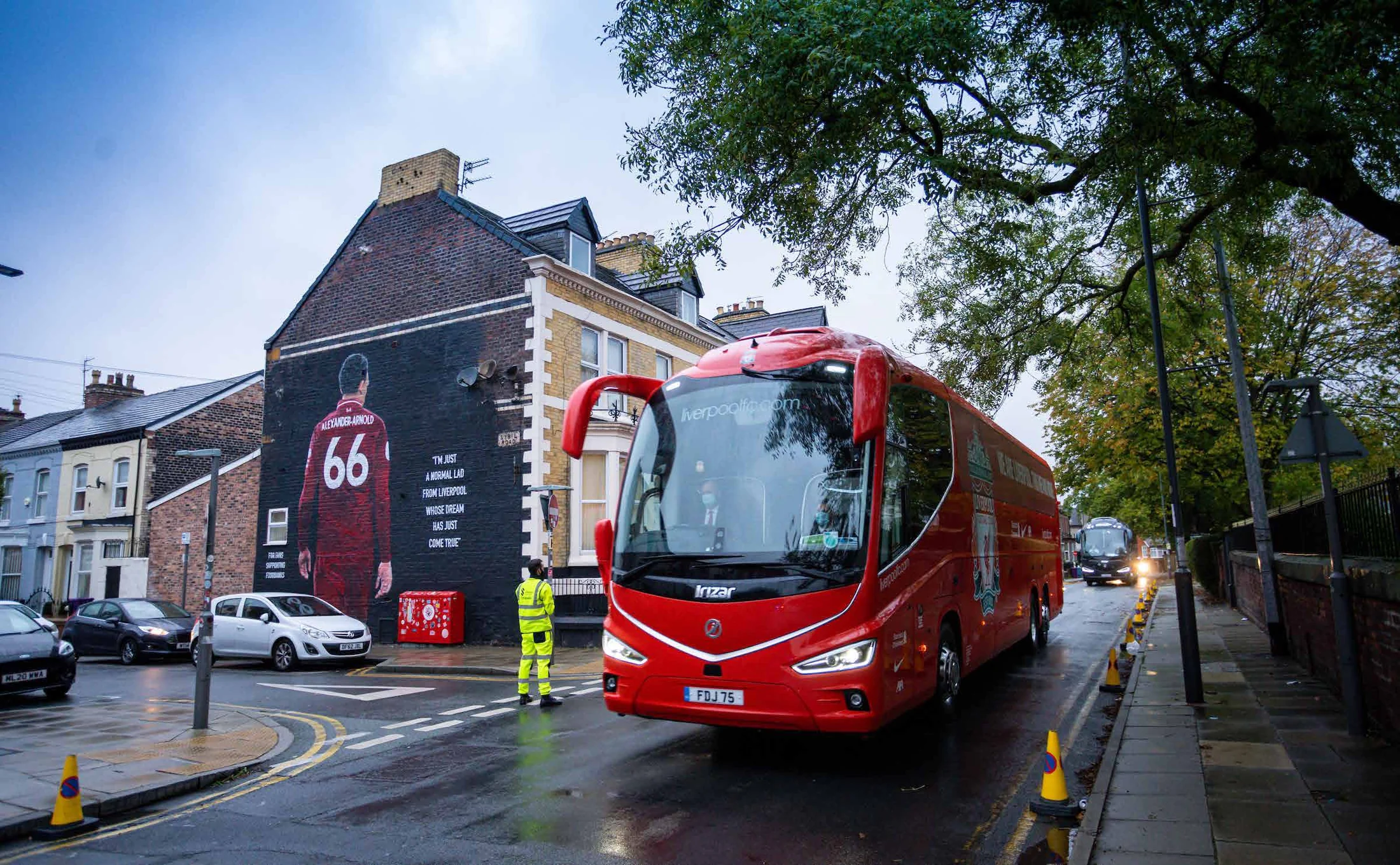 Liverpool’s open-top parade bus passing Trent Alexander-Arnold’s mural